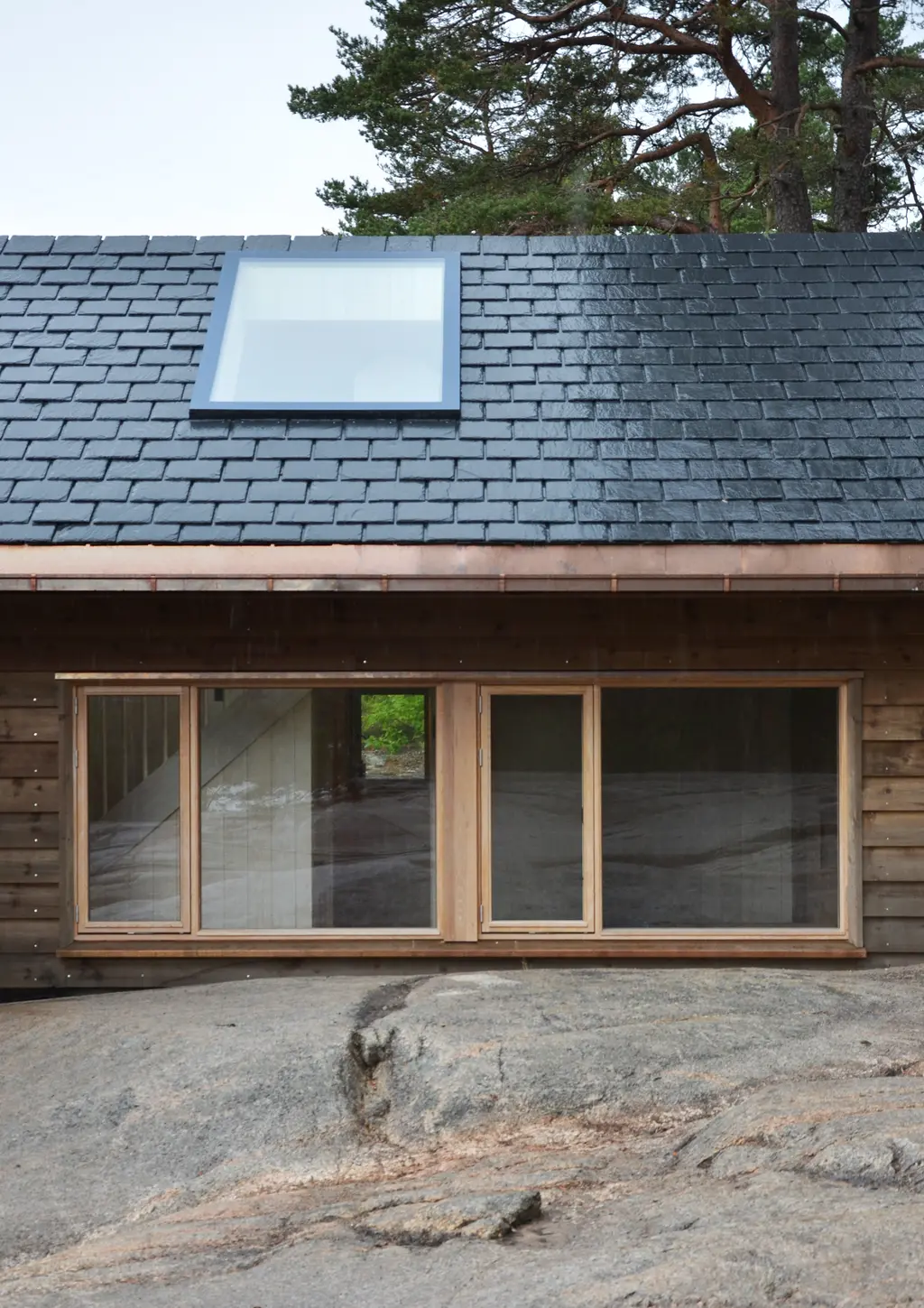 Veierland, Færder: a “by Sørvindu” rooflight set into the pitched roof above a timber facade