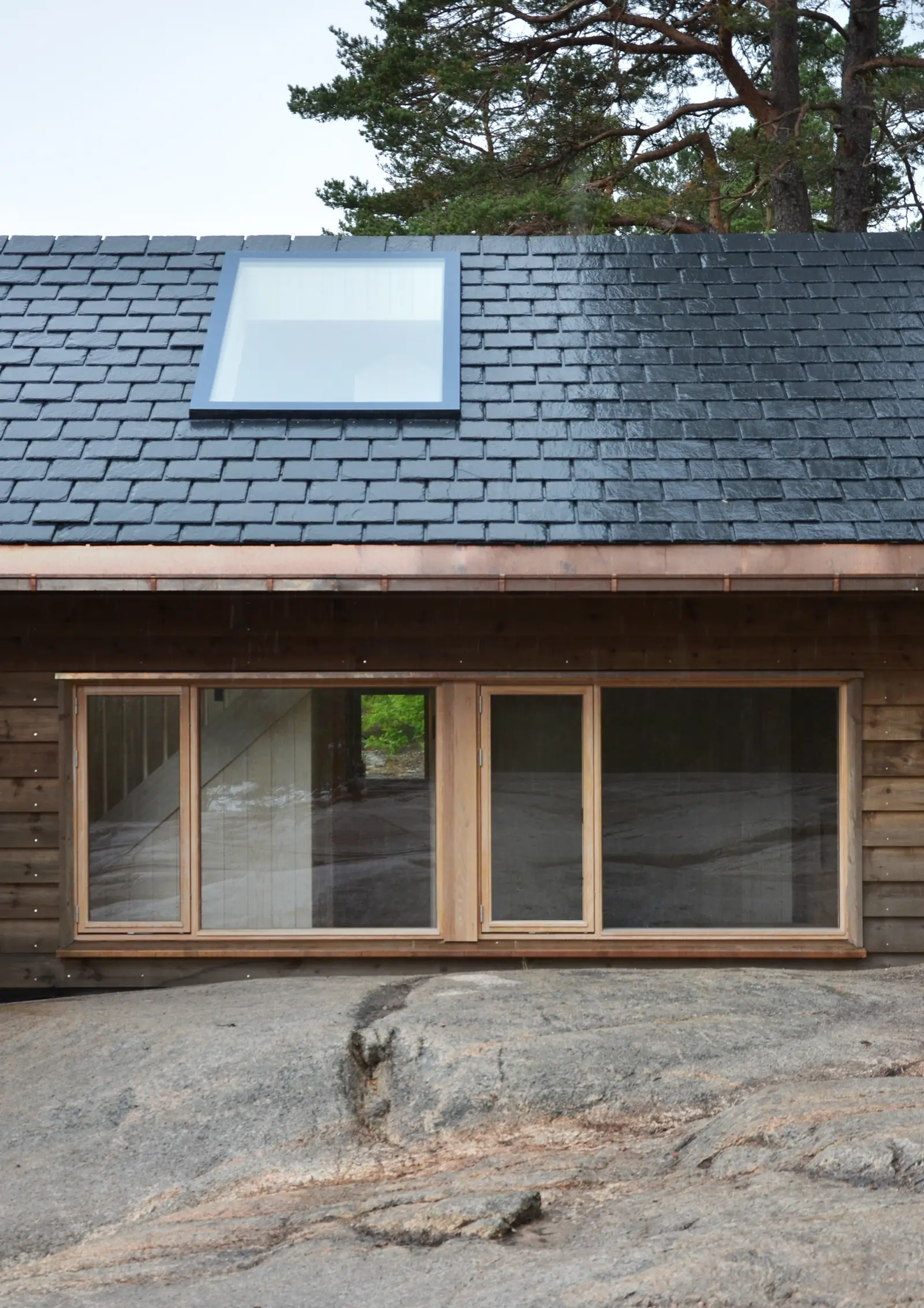 Veierland, Færder: a “by Sørvindu” rooflight set into the pitched roof above a timber facade